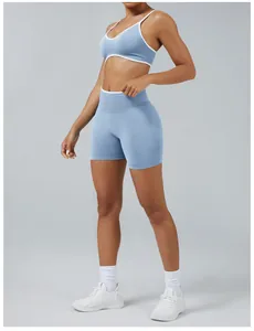 Detail shot of two-piece blue yoga set featuring color block sports bra and shorts