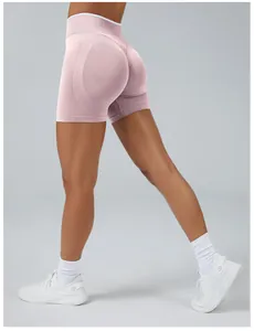 Back view of pink seamless yoga shorts for women featuring a peach butt lift design