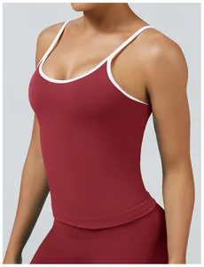 Close-up detail of burgundy tight yoga tank top featuring white contrast piping trim
