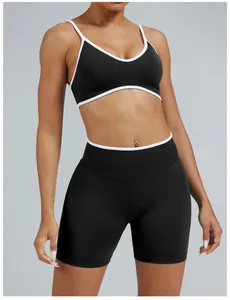 Detail view of women's black and white contrast trim sports bra and biker shorts set