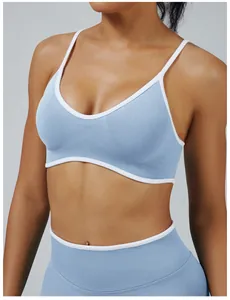 Detail shot of light blue sports bra featuring white piping and seamless ribbed fabric