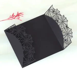 Detail der schwarzen Halloween-Einladung mit lasergeschnittenem Spinnennetz-Design.