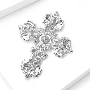 Detailed macro view of the silver alloy cross brooch back and secure safety clasp