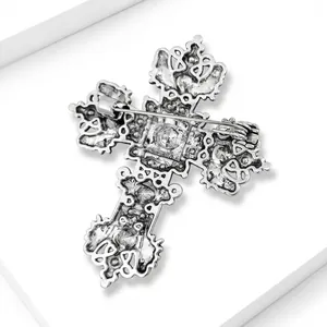 Detailed back view of vintage silver alloy cross brooch with pin mechanism
