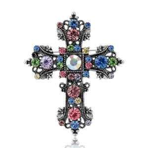 Elegant vintage silver alloy cross brooch featuring colorful rhinestones on a white backdrop