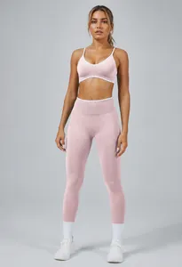 Professional view of pink two-piece seamless yoga set including sports bra and leggings