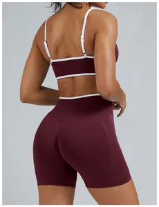 Detailed back view of a burgundy yoga set featuring white contrast trim and high waist