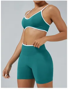 Detail shot of a teal yoga set with white contrast piping for fitness.