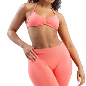 Seamless peach halter yoga bra and high-waist sports leggings set for training