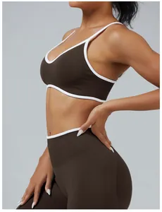 Detail of brown sports bra with white contrast trim and high-waisted leggings