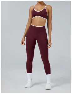 Front view of a woman wearing a maroon seamless yoga set with white trim details