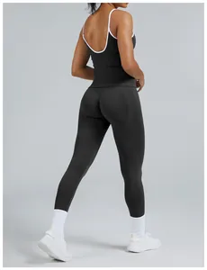 Detailed back view of women's black athletic tank top with white trim and leggings