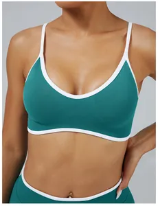 Close-up of teal contrast strap sports bra with white trim and ribbed band