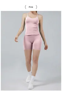 Two-piece pink yoga set featuring camisole top and matching fitted athletic shorts