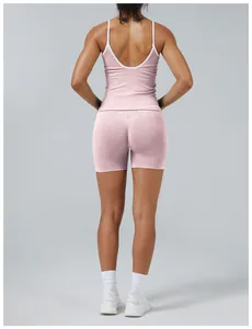 Rear view of pink two-piece yoga set featuring contrast white trim and open back design