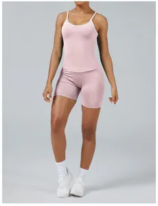 Front view of a pink two-tone women's yoga set with white trim camisole and shorts.