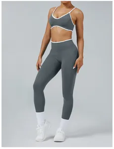 Detail view of grey seamless yoga set with white trim on a female fitness model