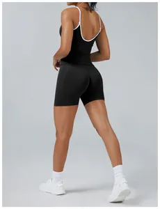 Back view of women's contrast yoga set with open back tank and black tight shorts