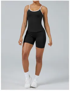 Detail view of women's black and white tight-fit quick-dry yoga set in gray background