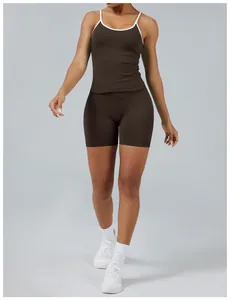 Close-up of brown two-piece yoga set with white contrast trim on a fitness model