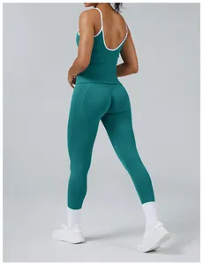 Teal sports tank top and leggings set with white contrast piping for yoga and gym