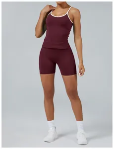 Detail showing burgundy two-piece yoga set with white trim for athletic fitness.
