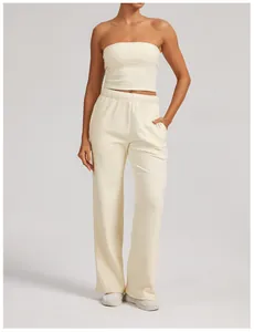 Two-piece cream lounge set featuring bandeau top and high-waist wide-leg sweatpants.