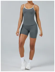 Close-up showing the detail of a women's grey two-piece yoga set with white piping.