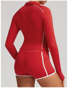 Back view of red long-sleeve yoga jacket and matching shorts with white contrast piping