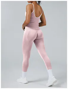 Detailed back view of a pink two-piece yoga set with white trim and racerback top