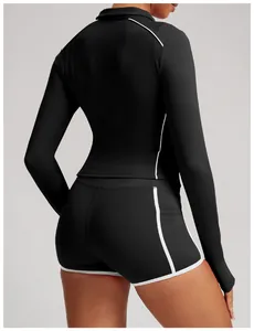 Slim-fit black women's yoga set back view with stylish white contrast piping detail
