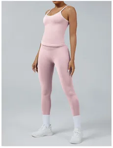 Detail showing a pink two-tone women's yoga set with white straps and long leggings