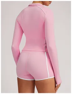 Close-up back view of pink yoga set with white contrast piping and slim fit design