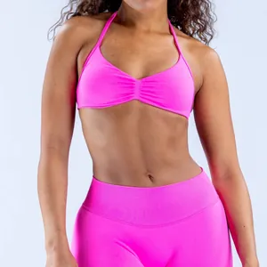 Vibrant neon pink seamless halter sports bra made from high-elastic matte nylon material.