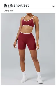 Detailed view of women's cherry red contrast sports bra and shorts yoga set on model