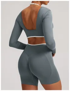 Back view of seamless blue-grey yoga set with long sleeve crop top and biker shorts