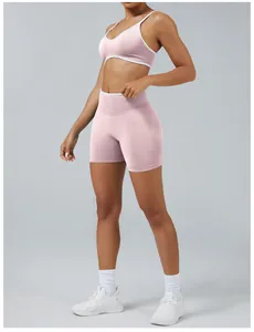Women's pink color-block yoga set featuring a backless sports bra and tight shorts.