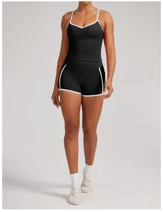 Detail view of women's black quick-dry yoga tank top and shorts set with white piping
