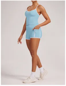 Detailed side view of women's light blue yoga tank top and shorts with white trim