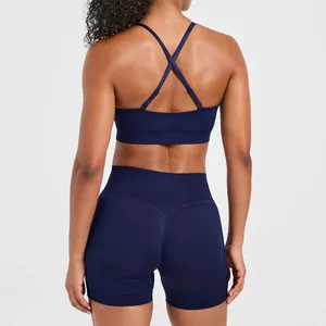Back view of navy blue seamless sports bra featuring double cross-back straps detail for yoga