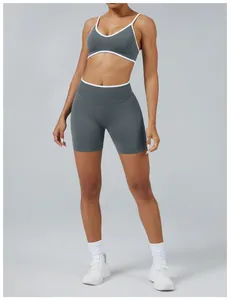Front view of grey two-piece sports set with contrast white trim on bra and shorts