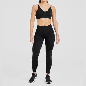 Front view of high-intensity seamless black yoga bra and matching workout leggings