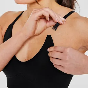 Detail view showing the adjustable strap clip on a black seamless yoga sports bra.