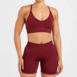 Close-up of a maroon seamless sports bra and high-waisted yoga shorts set on a model