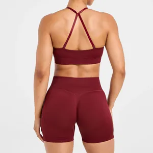 Back view of burgundy seamless yoga bra with cross straps and high waist shorts set