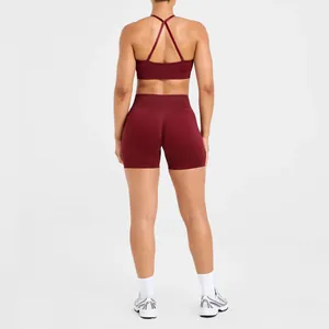 Back view of professional maroon seamless yoga bra and high-waist sports shorts set