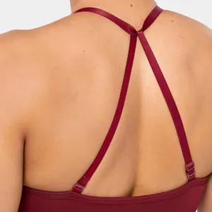 Close-up detail of burgundy seamless yoga bra with adjustable double straps on back.