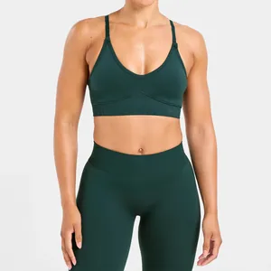 Close-up detail of a dark green high-impact seamless yoga sports bra with ribbed textures.