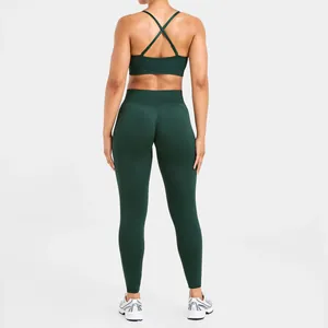 Back view of a dark green seamless yoga bra with criss-cross straps and matching leggings