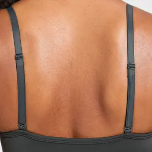 Close-up detail of a dark grey seamless yoga bra with adjustable double straps